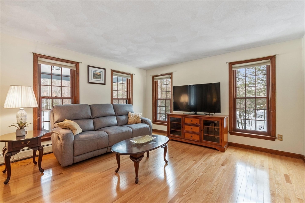 53 Throne Hill Road Groton, MA 01450 - Photo 18 of 38 a living room with furniture and a flat screen tv