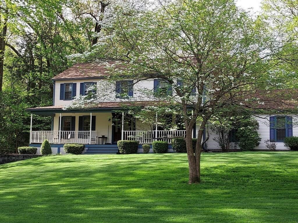 53 Throne Hill Road Groton, MA 01450 - Photo 2 of 38 a front view of a house with a garden