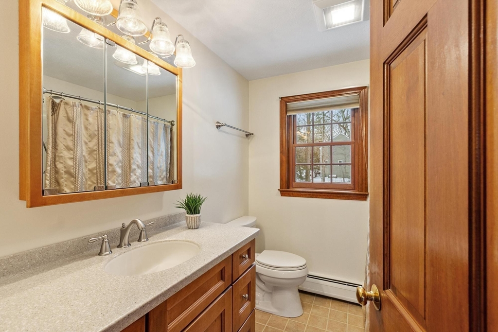 53 Throne Hill Road Groton, MA 01450 - Photo 21 of 38 a bathroom with a granite countertop sink toilet and mirror