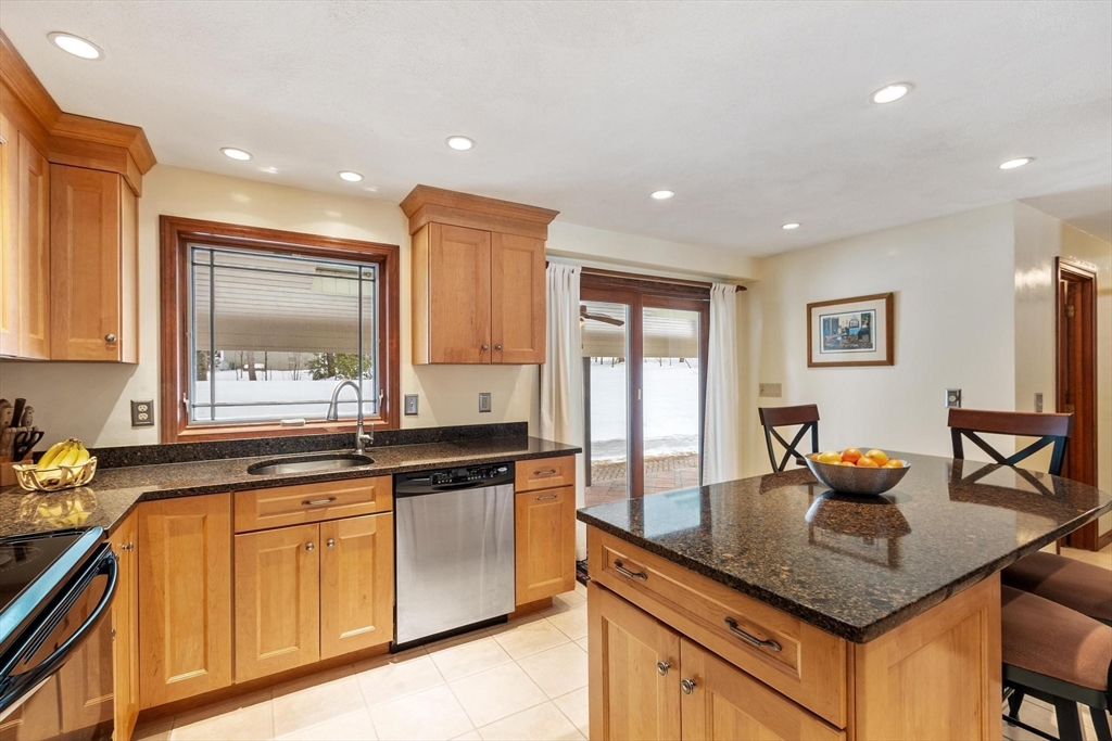 53 Throne Hill Road Groton, MA 01450 - Photo 8 of 38 a kitchen with granite countertop a sink and white cabinets
