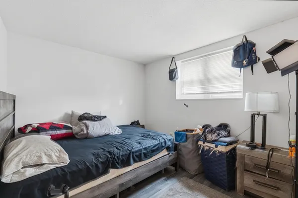 a bedroom with furniture and a lamp