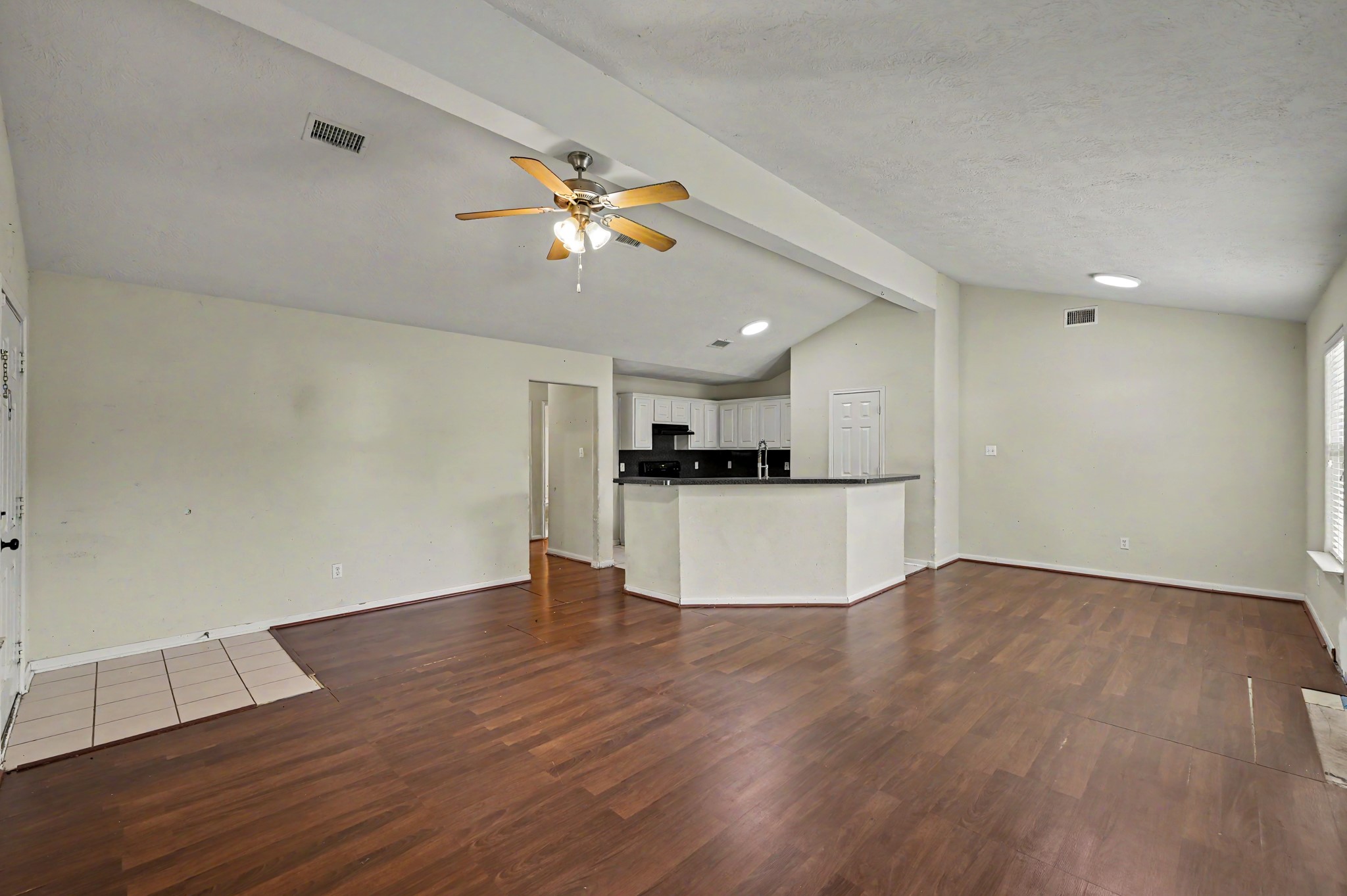 4619 Comal River Loop Spring, TX 77386 - Photo 3 of 16 This living room has tons of space with a formal dining space on the right side and bar seating around the island.