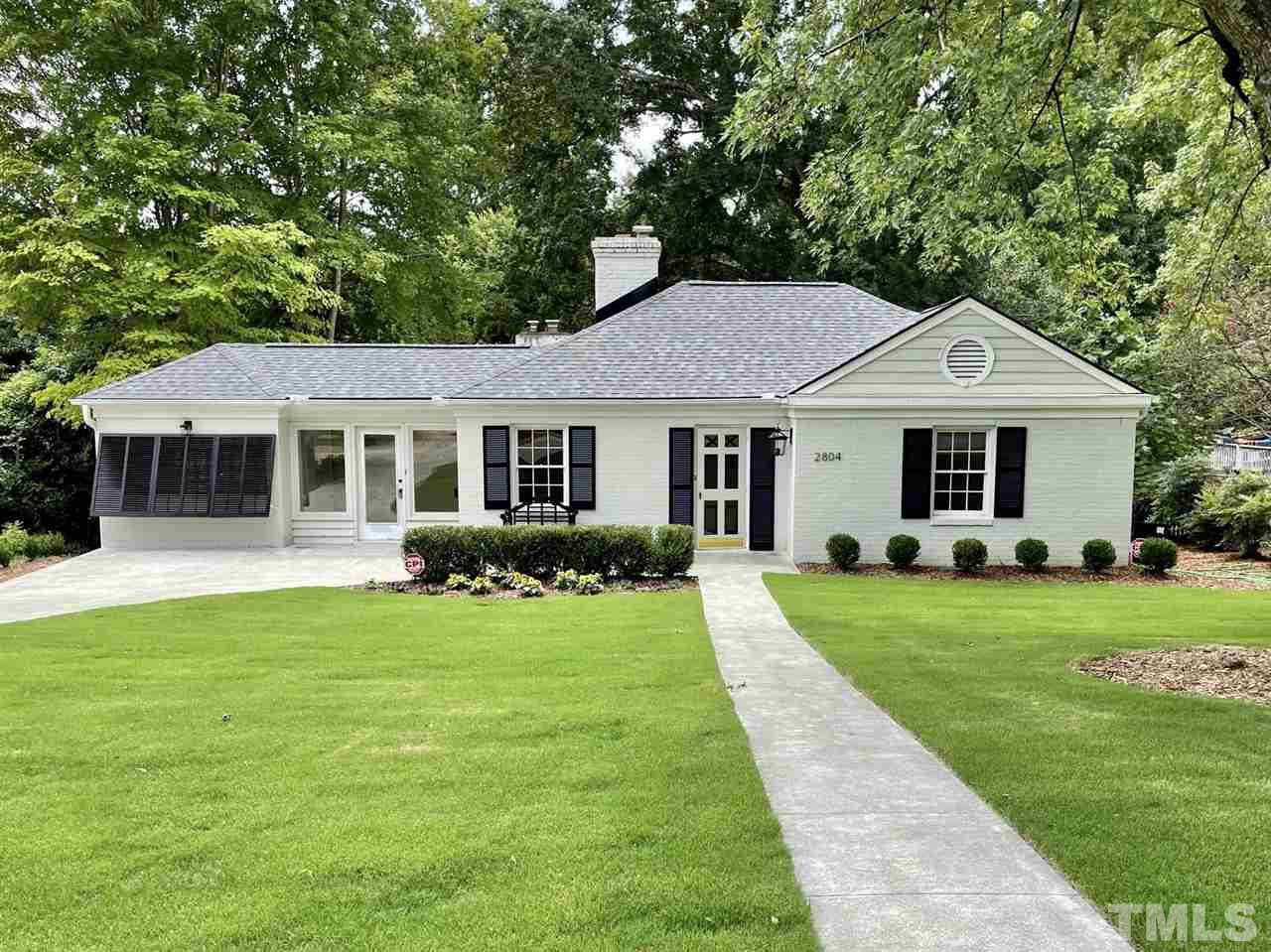 2804 Anderson Drive Raleigh, NC 27608 - Photo 1 of 23 a front view of a house with a yard and garage