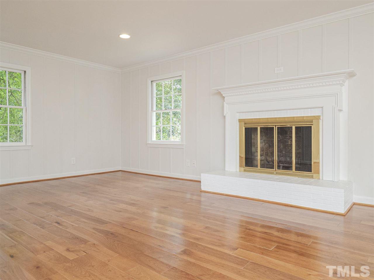 2804 Anderson Drive Raleigh, NC 27608 - Photo 12 of 23 a view of an empty room with wooden floor and a window