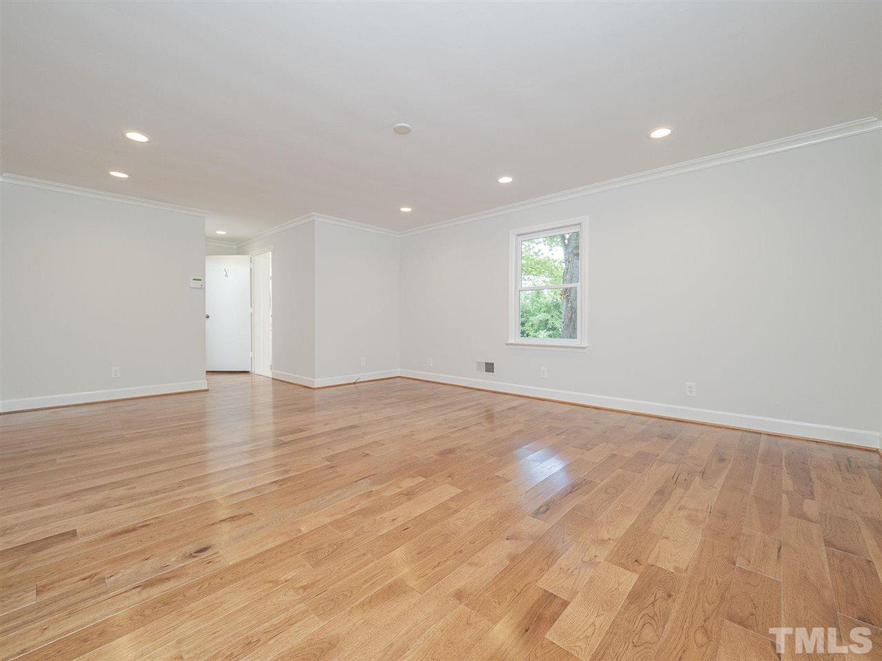 2804 Anderson Drive Raleigh, NC 27608 - Photo 14 of 23 an empty room with wooden floor and windows