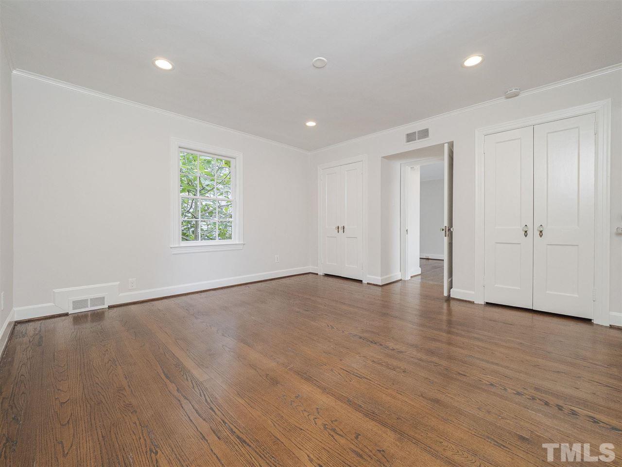 2804 Anderson Drive Raleigh, NC 27608 - Photo 17 of 23 a view of an empty room with wooden floor and a window