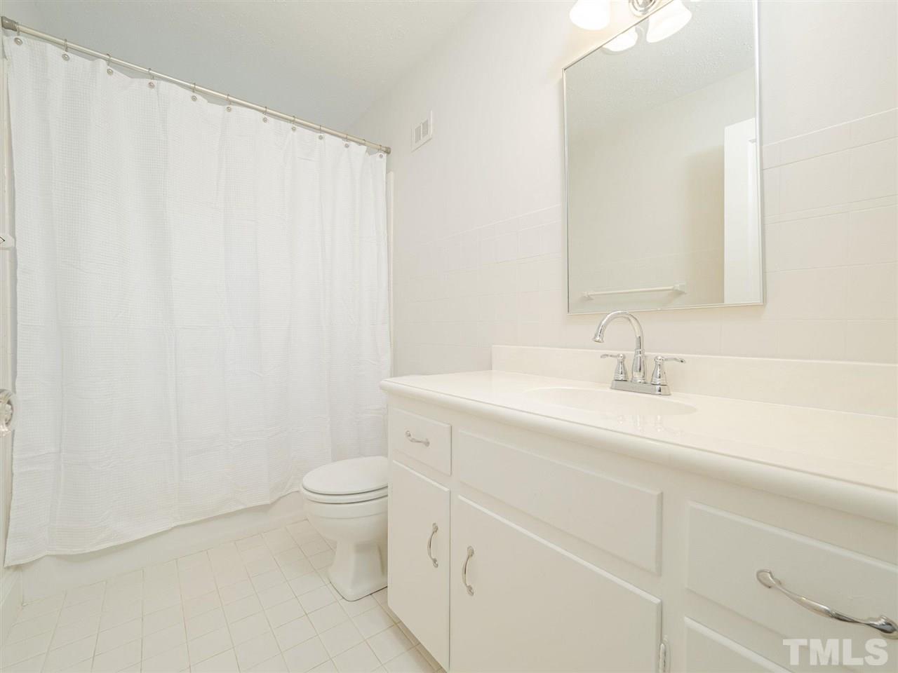 2804 Anderson Drive Raleigh, NC 27608 - Photo 18 of 23 a bathroom with a sink a toilet and a mirror