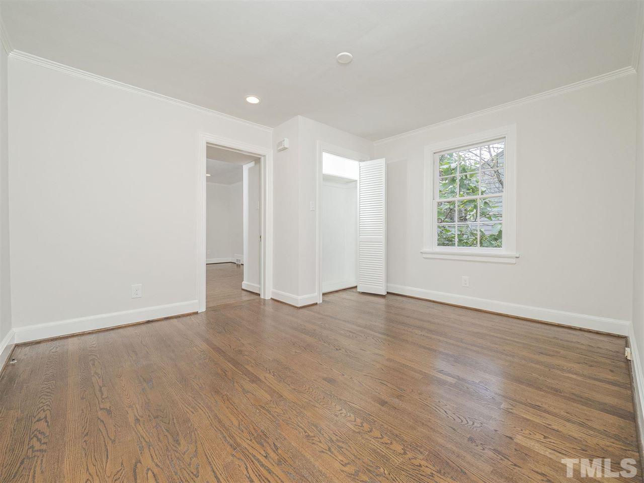 2804 Anderson Drive Raleigh, NC 27608 - Photo 19 of 23 an empty room with wooden floor and windows