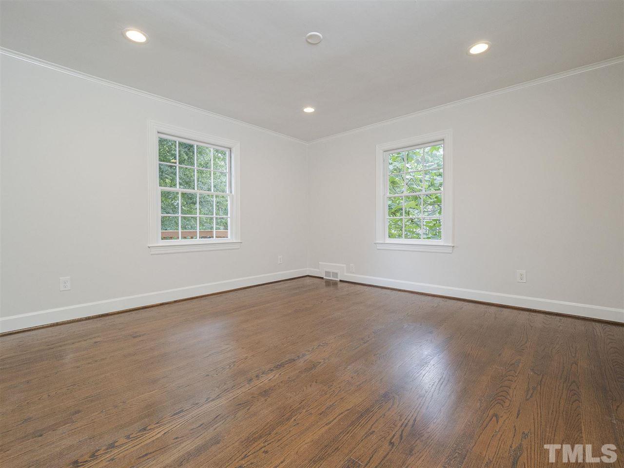 2804 Anderson Drive Raleigh, NC 27608 - Photo 20 of 23 an empty room with wooden floor and windows