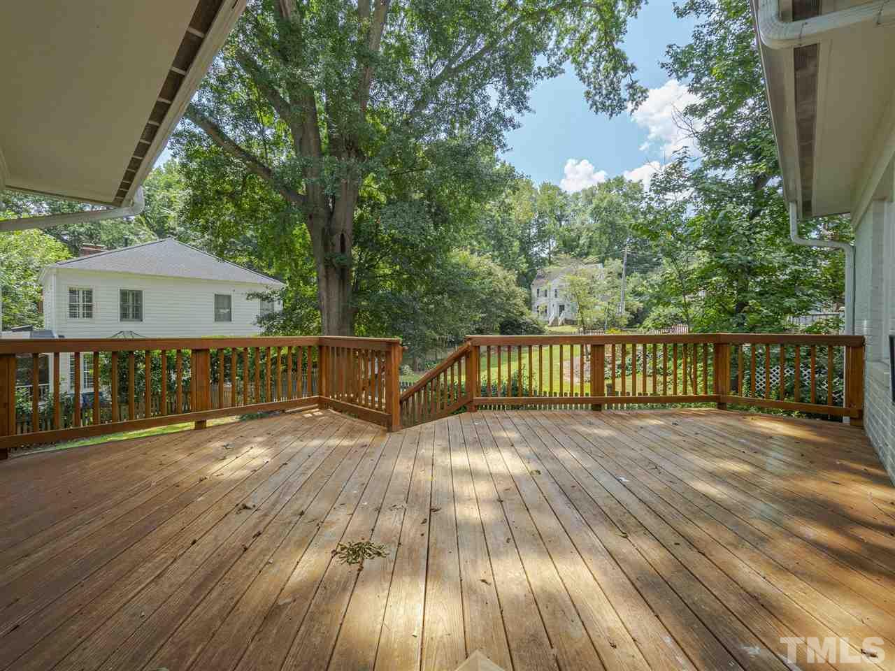 2804 Anderson Drive Raleigh, NC 27608 - Photo 22 of 23 a view of balcony with wooden floor and fence