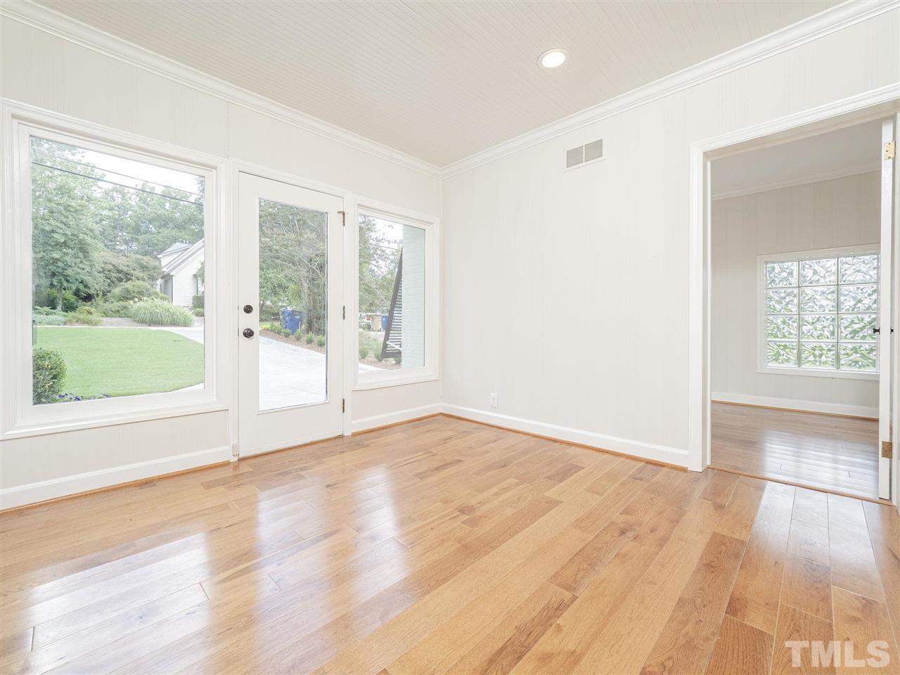 2804 Anderson Drive Raleigh, NC 27608 - Photo 6 of 23 an empty room with wooden floor and windows