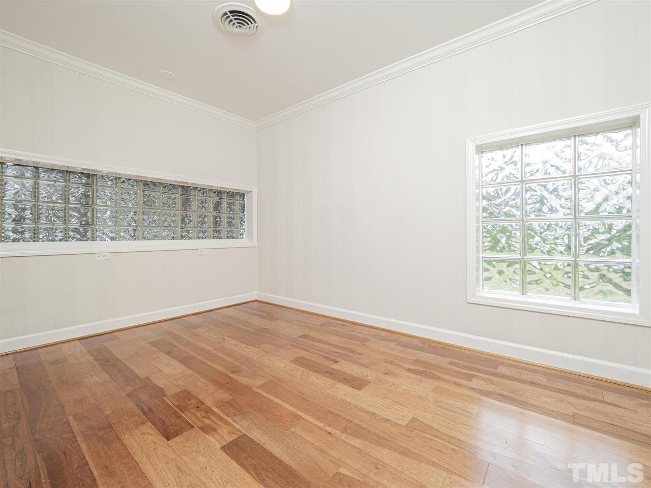 2804 Anderson Drive Raleigh, NC 27608 - Photo 7 of 23 an empty room with wooden floor and windows