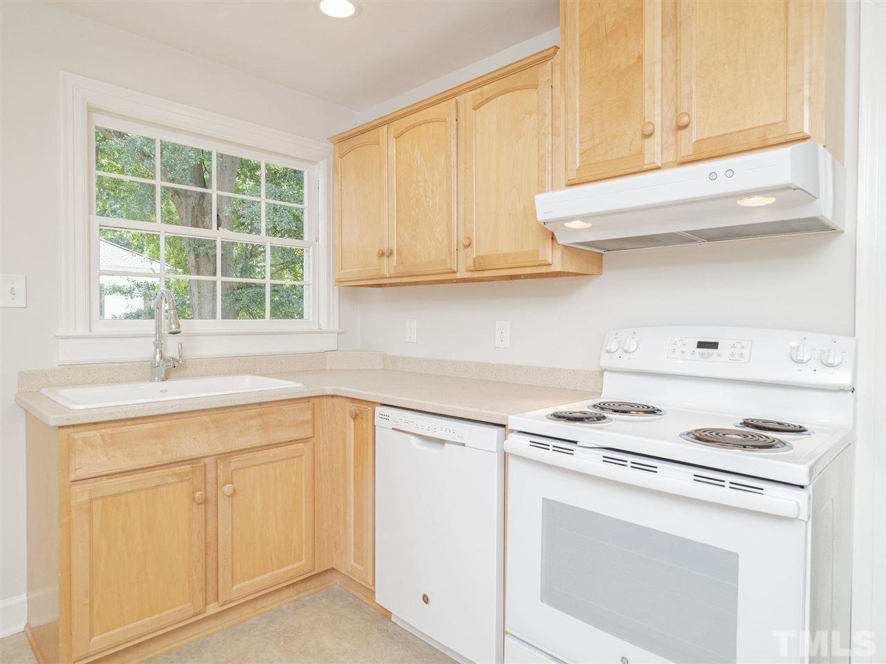 2804 Anderson Drive Raleigh, NC 27608 - Photo 10 of 23 a kitchen with white cabinets and a stove