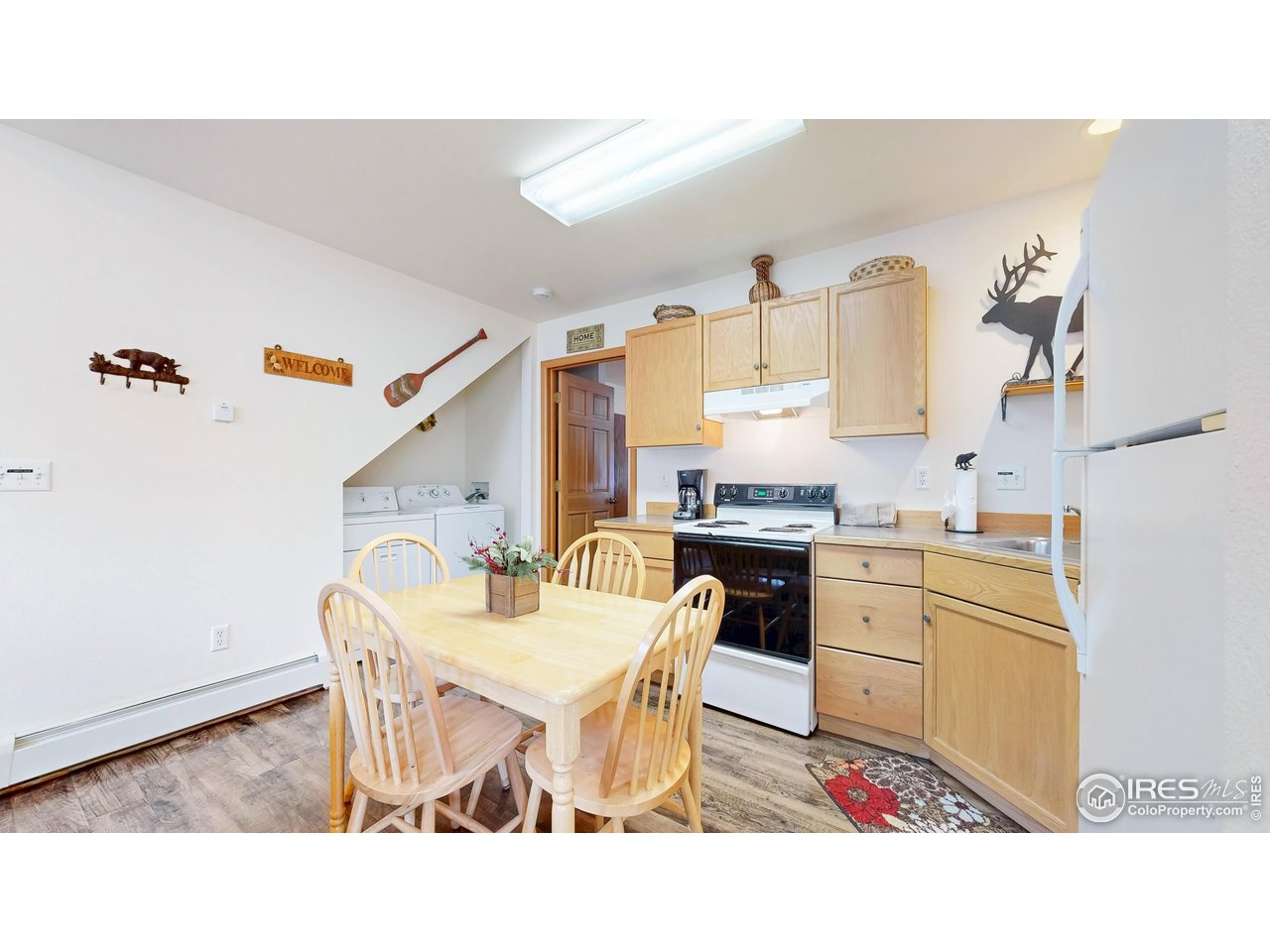 2120 Fall River Road, Unit 2 Estes Park, CO 80517 - Photo 11 of 39 a kitchen with a dining table chairs and sink