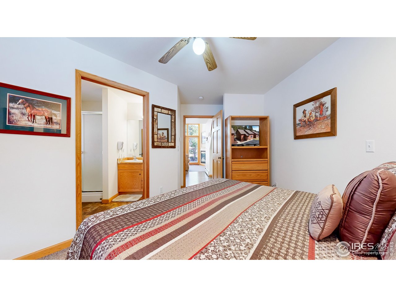 2120 Fall River Road, Unit 2 Estes Park, CO 80517 - Photo 12 of 39 a bedroom with a bed and a chandelier