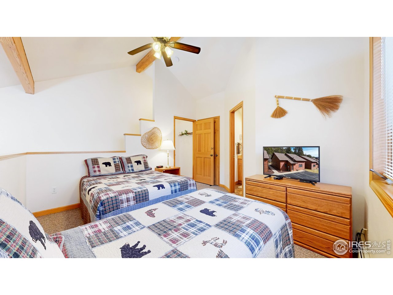 2120 Fall River Road, Unit 2 Estes Park, CO 80517 - Photo 20 of 39 a bedroom with a bed and a painting on the wall