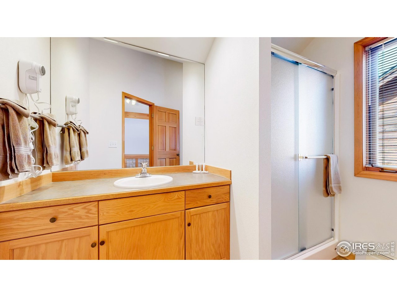 2120 Fall River Road, Unit 2 Estes Park, CO 80517 - Photo 21 of 39 a bathroom with a sink a mirror and a bathtub