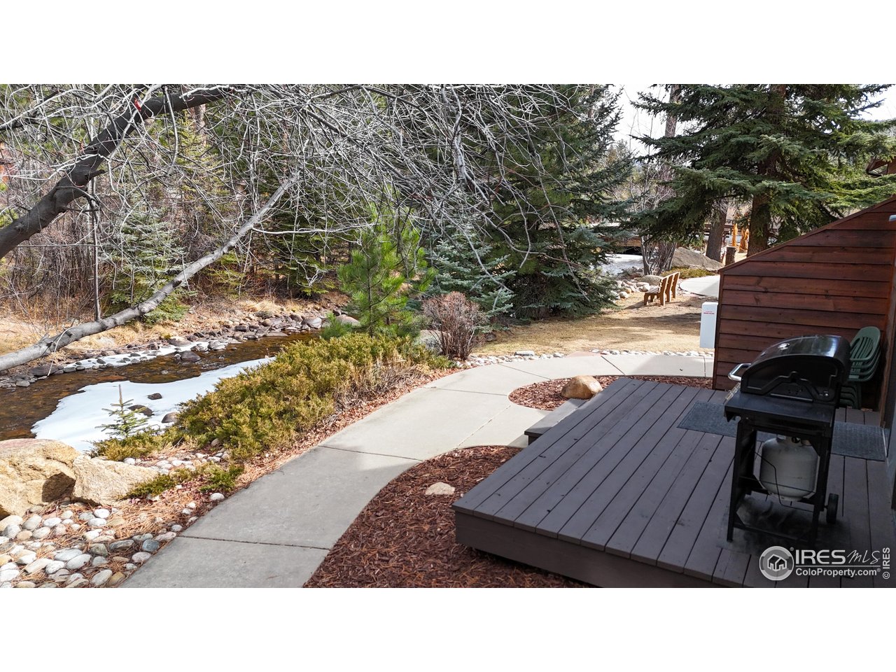 2120 Fall River Road, Unit 2 Estes Park, CO 80517 - Photo 3 of 39 a wooden bench sitting in the backyard
