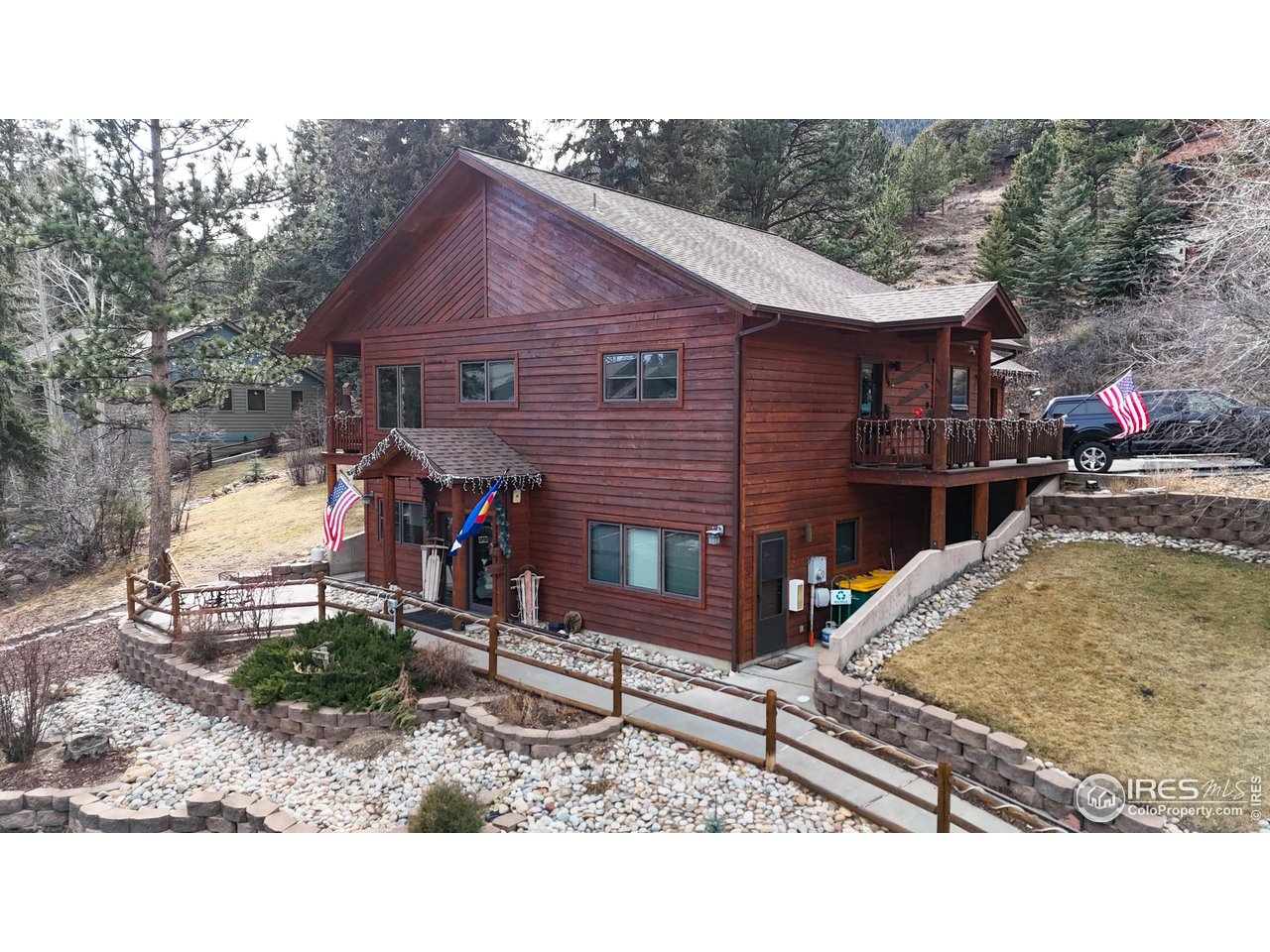 2120 Fall River Road, Unit 2 Estes Park, CO 80517 - Photo 32 of 39 a backyard of a house with barbeque oven table and chairs