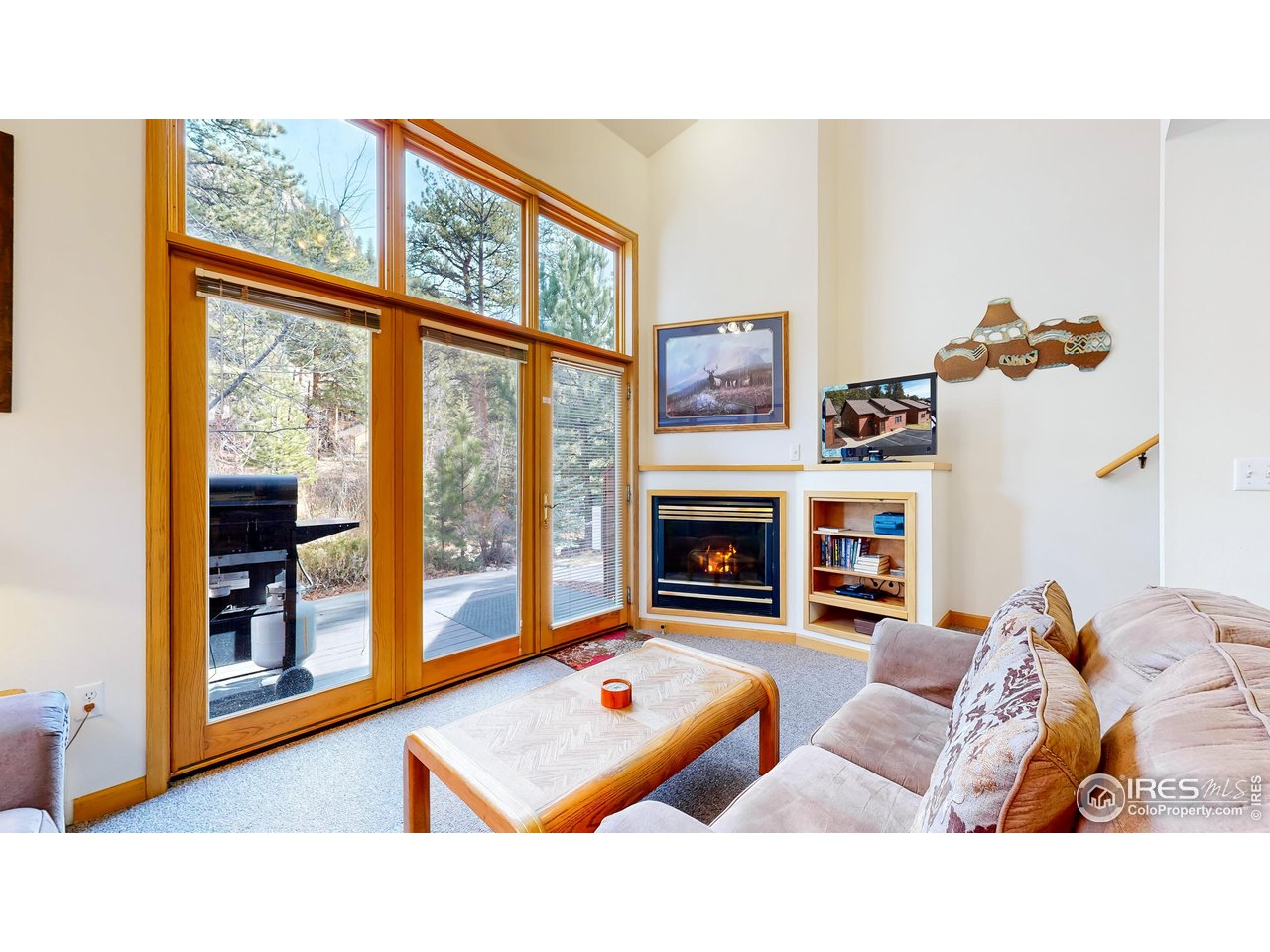 2120 Fall River Road, Unit 2 Estes Park, CO 80517 - Photo 5 of 39 a living room with furniture and a fireplace