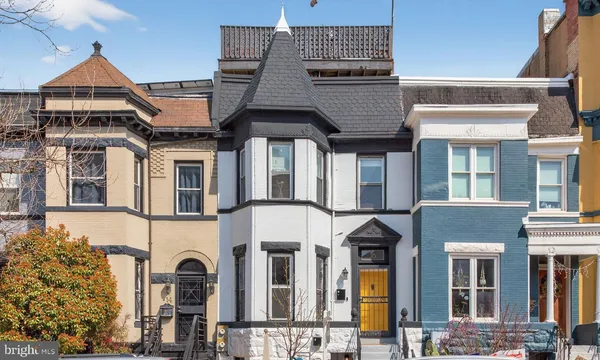 a front view of a residential apartment building with a yard