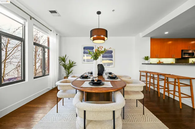 a dining room with furniture and wooden floor