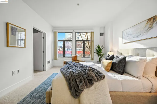 a bedroom with bed and a large window