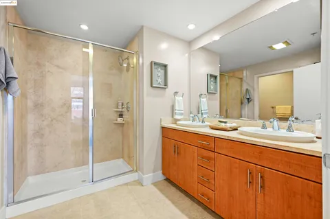 a bathroom with a shower sink and mirror