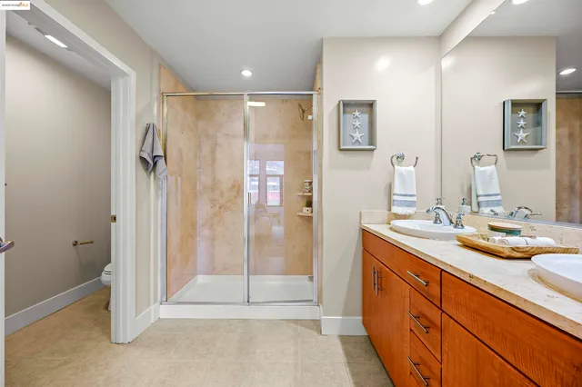 a spacious bathroom with a mirror sink and shower