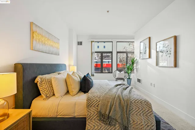 a bedroom with a bed and a large window