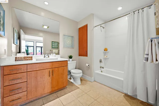a bathroom with a double vanity sink toilet and shower