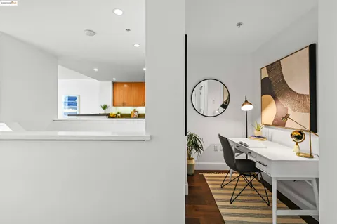 a living room with furniture a mirror and a clock