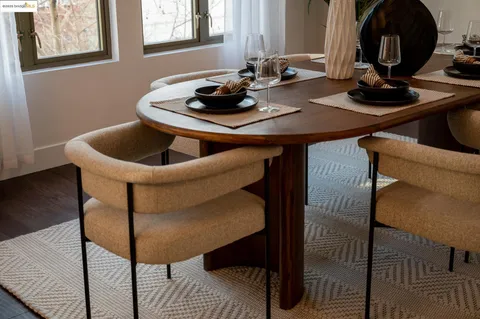 a dining room with furniture and wooden floor