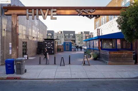 a view of city with the shops and large trees