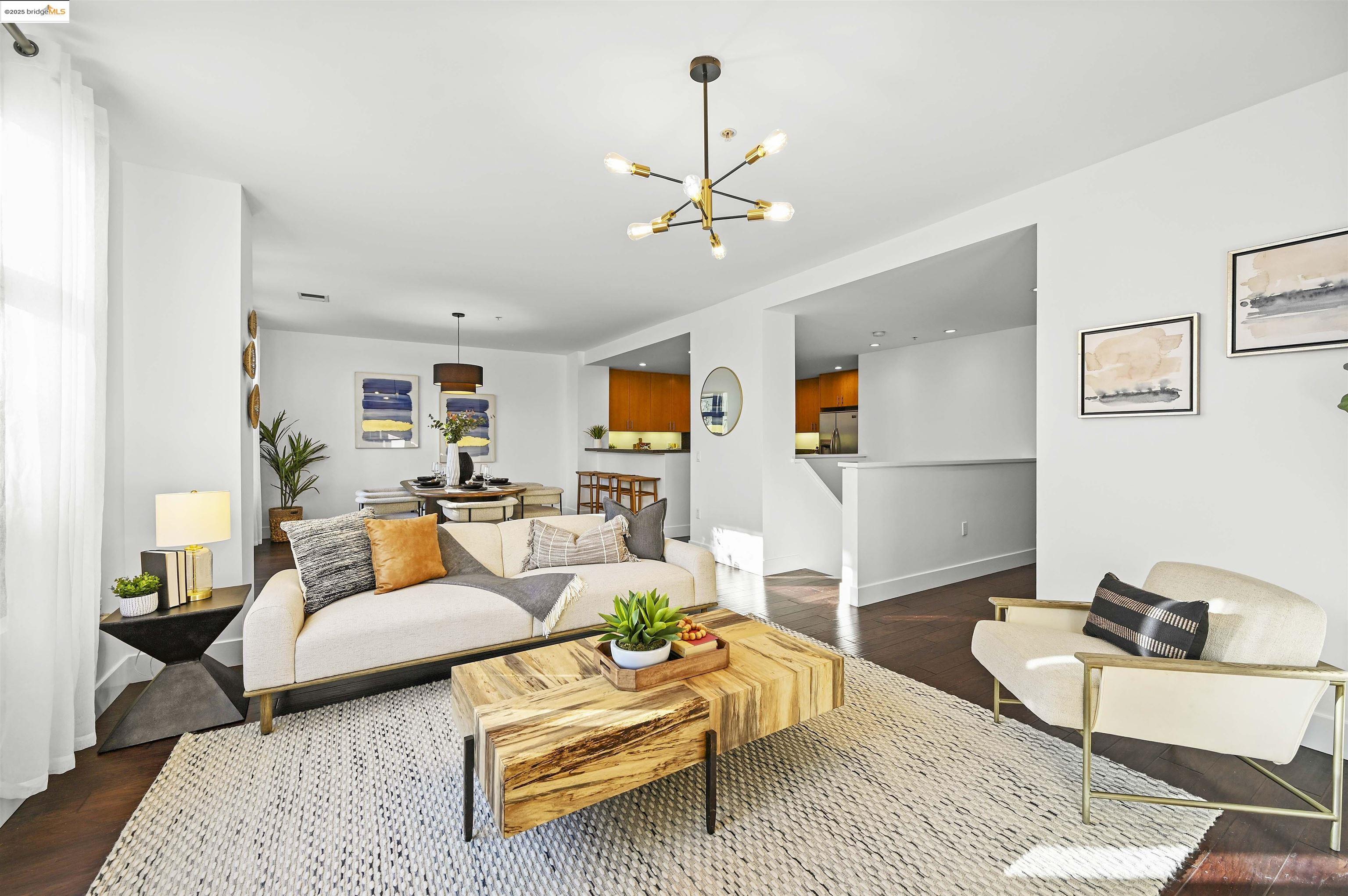 438 West Grand Avenue, Unit 422 Oakland, CA 94612 - Photo 6 of 52 Living area featuring dark wood-style flooring and a chandelier