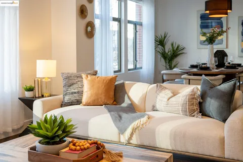 a living room with furniture and a potted plant