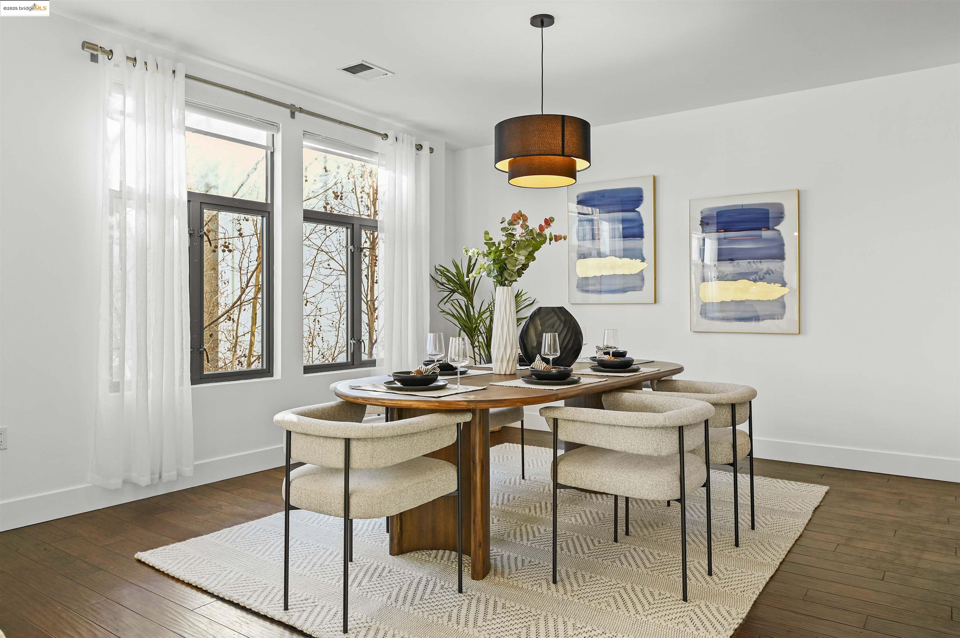 438 West Grand Avenue, Unit 422 Oakland, CA 94612 - Photo 10 of 52 Dining room featuring baseboards and dark wood-style floors