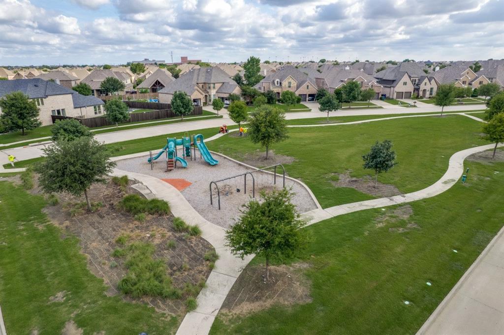14215 Raspberry Lane Frisco, TX 75035 - Photo 28 of 30 Community park with playground, swings, and meandering concrete pathways