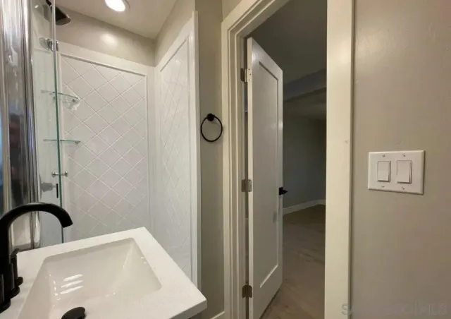 a bathroom with a sink and a shower