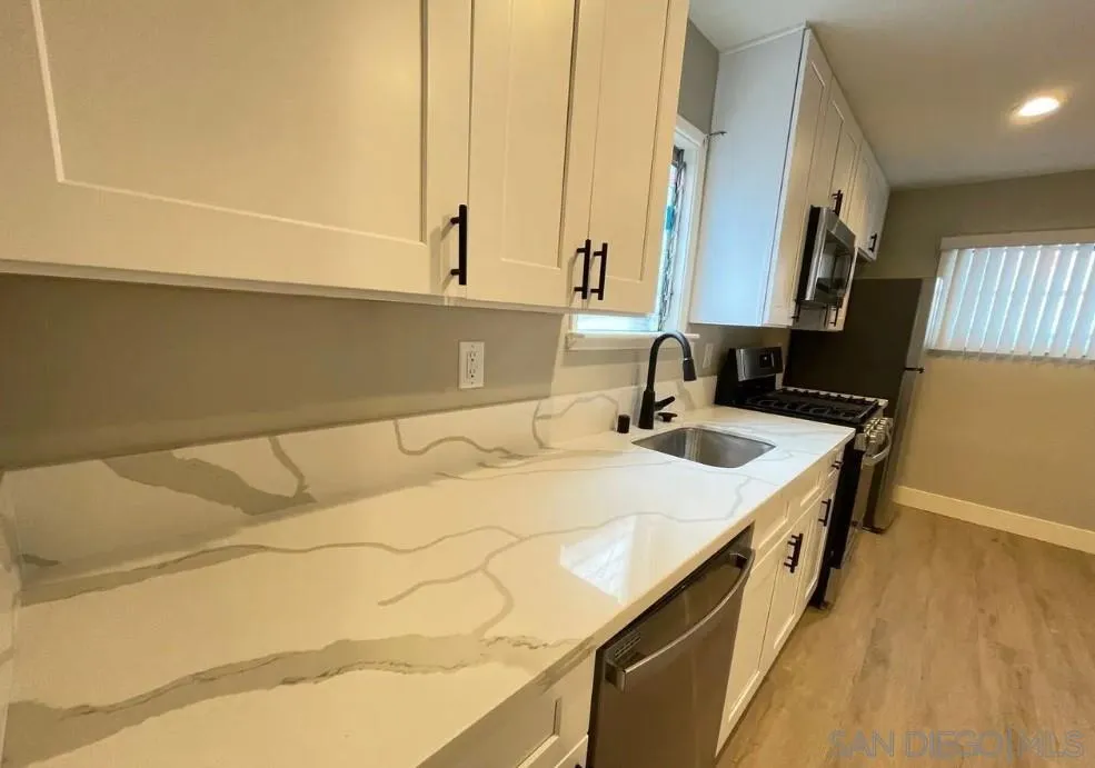 2136 Reed Avenue San Diego, CA 92109 - Photo 14 of 41 a bathroom with a sink and a mirror