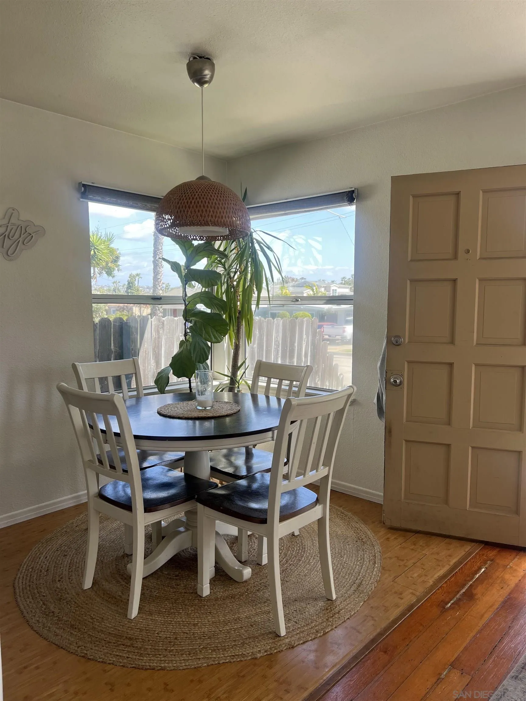 2136 Reed Avenue San Diego, CA 92109 - Photo 19 of 41 a dining room with furniture a chandelier and wooden floor