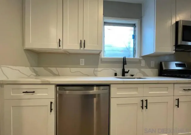 a kitchen with a sink and cabinets