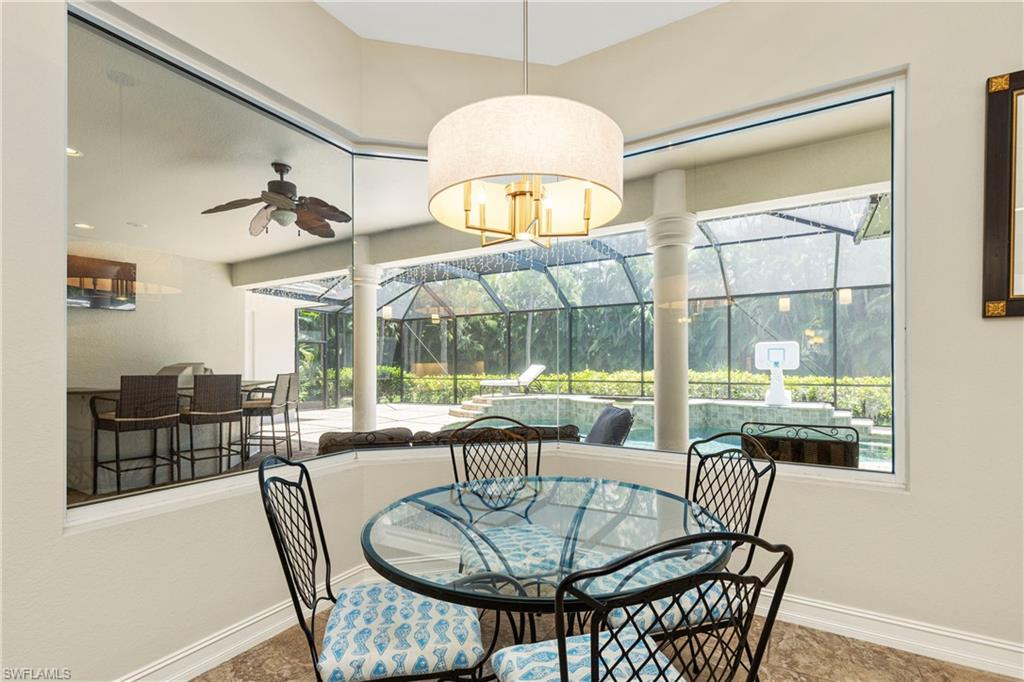 2116 Harlans Run Naples, FL 34105 - Photo 14 of 35 Dining space with a sunroom, ceiling fan, and decorative columns