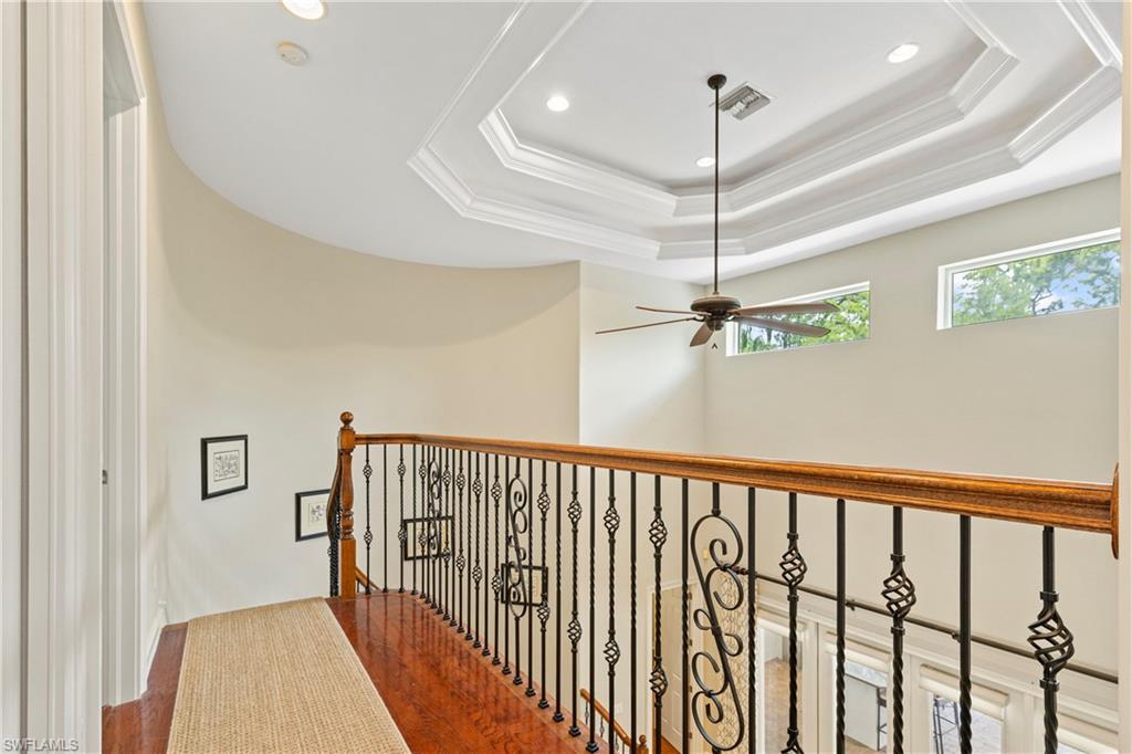 2116 Harlans Run Naples, FL 34105 - Photo 26 of 35 Hall with wood finished floors, ornamental molding, recessed lighting, and a tray ceiling