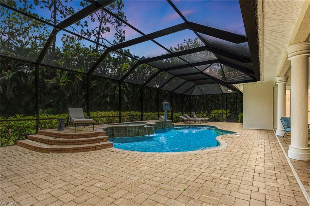 2116 Harlans Run Naples, FL 34105 - Photo 33 of 35 View of pool featuring a pool with connected hot tub, a patio area, and glass enclosure