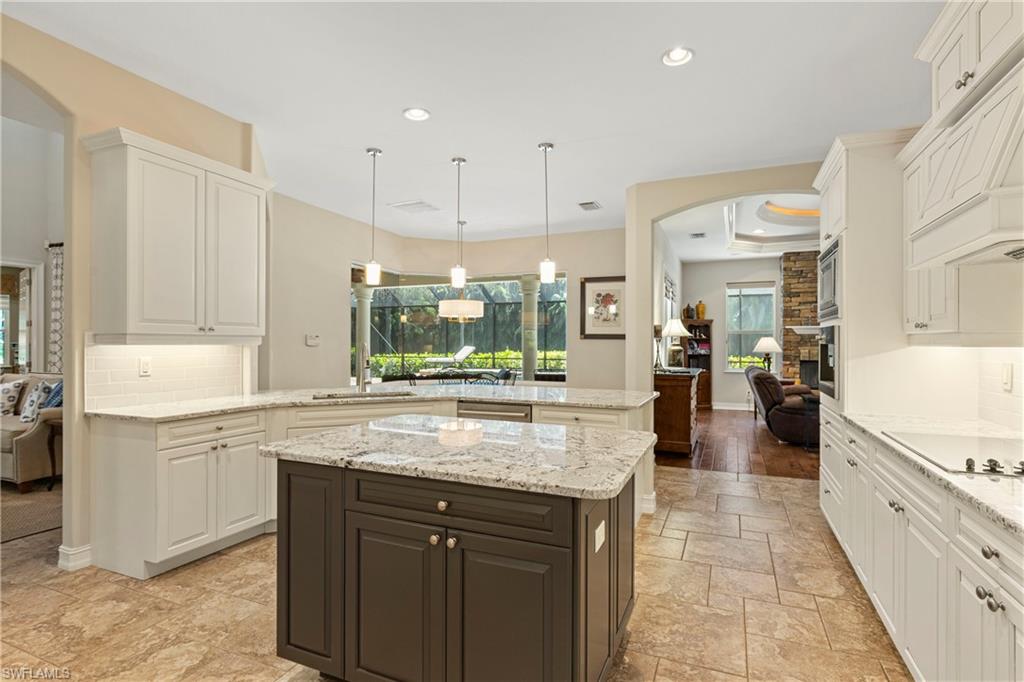 2116 Harlans Run Naples, FL 34105 - Photo 10 of 35 Kitchen with backsplash, recessed lighting, white cabinets, and a peninsula