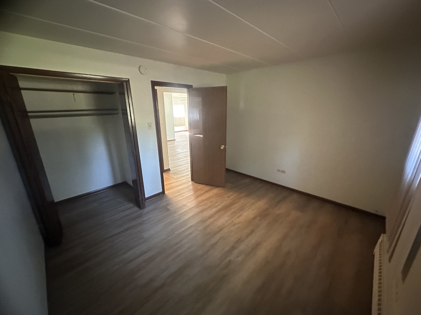 18550 Torrence Avenue, Unit 4 Lansing, IL 60438 - Photo 4 of 14 an empty room with wooden floor and closet