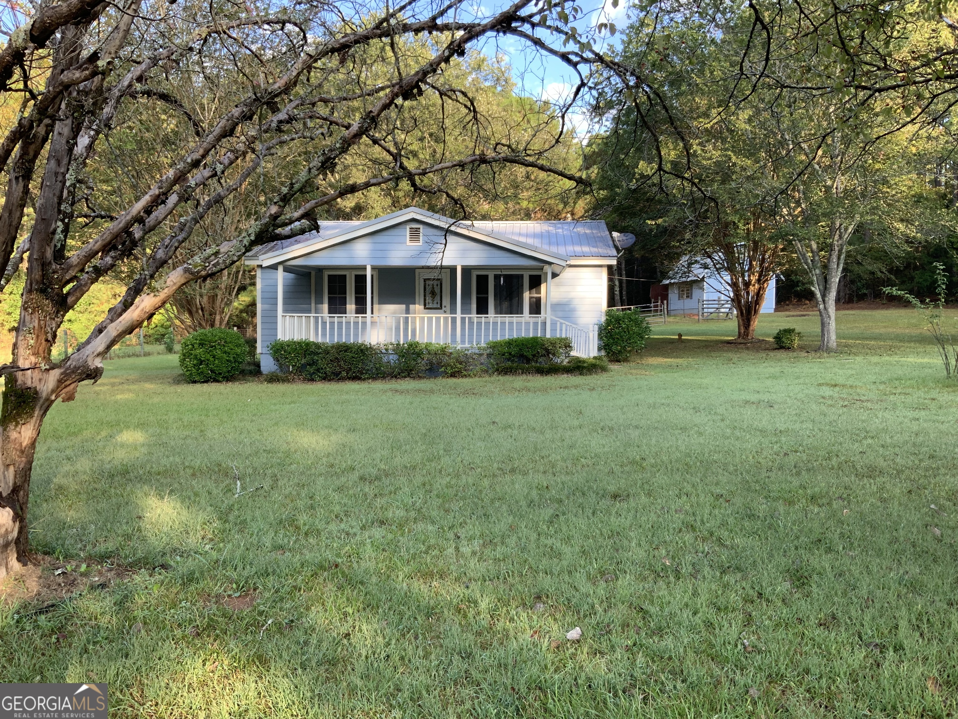 a front view of a house with a garden