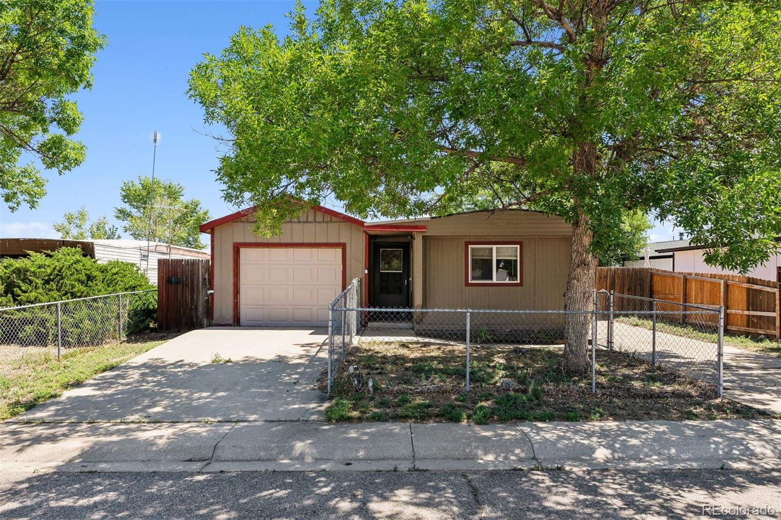 1044 Mac Davidson Circle Dacono, CO 80514 - Photo 1 of 25 a front view of a house with garden