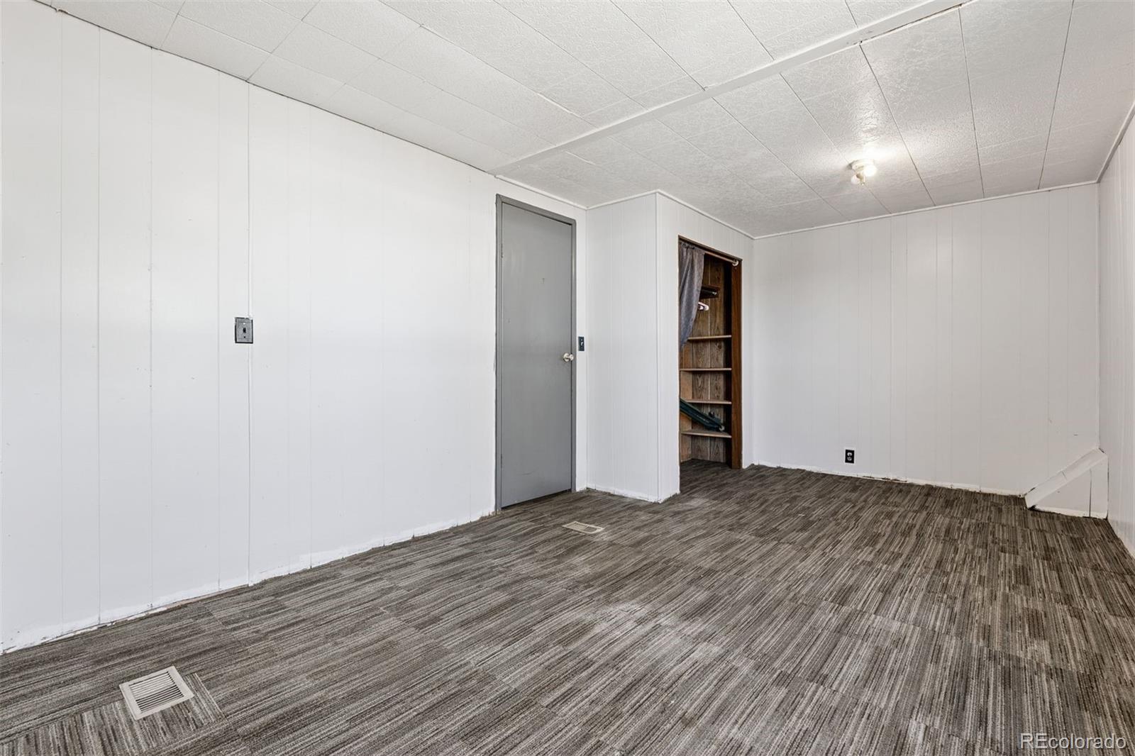 1044 Mac Davidson Circle Dacono, CO 80514 - Photo 11 of 25 a view of an empty room with wooden floor